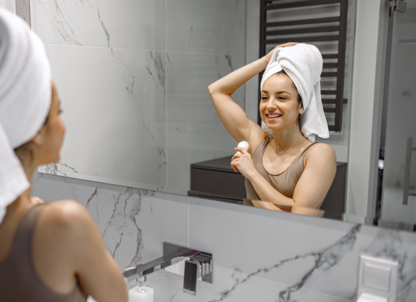 Imagen referencial de mujer colocándose desodorante tras ducharse.