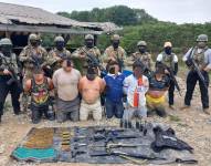 Imagen de los seis detenidos junto a las armas de fuego y municiones.