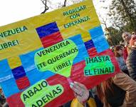 Una mujer sostiene un cartel en una concentración de ciudadanos venezolanos con motivo de las elecciones presidenciales en Venezuela, el 28 de julio de 2024, en Buenos Aires (Argentina).