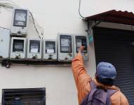 Imagen de un hombre revisando medidores de luz. Imagen referente a los cortes de energía en Ecuador.