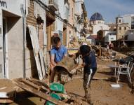 Vecinos de Chiva limpian sus hogares tras la DANA que ha asolado el sureste español y ha causado más de un centenar de muertos, este jueves.