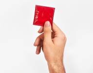Imagen referencial: Hombre sesteniendo un preservativo.