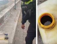 El agente civil de tránsito junto a la caneca con presunto material inflamable compuesto por diésel y aceite.