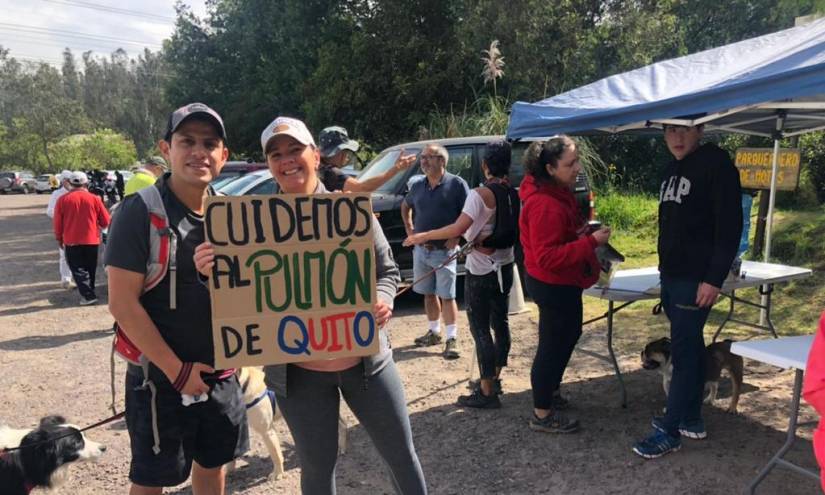 Dos personas muestran el cartel en el parqueadero del parque Metropolitano.