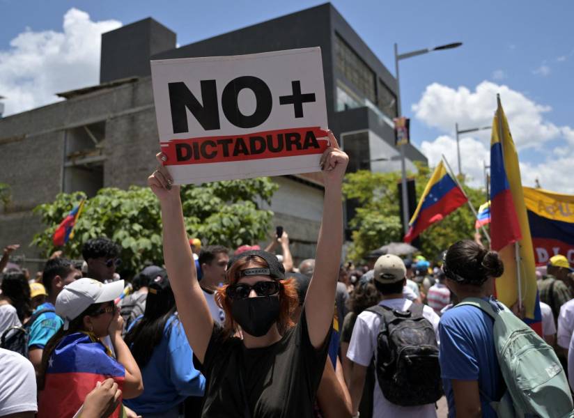 Una mujer sostiene un cartel en una protesta en Caracas contra el régimen de Nicolás Maduro.