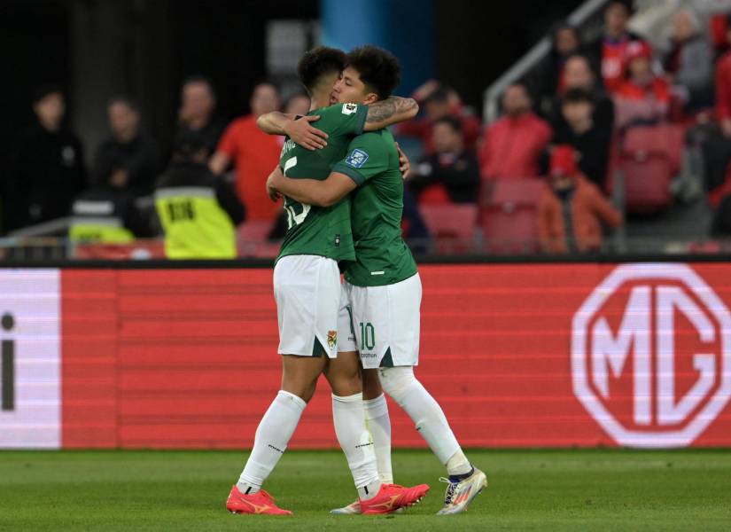 Bolivia's forward Miguel Terceros (R) celebrates with teammate midfielder Gabriel Villamil after scoring his team's second goal during the 2026 FIFA World Cup South American qualifiers football match between Chile and Bolivia, at the National stadium in Santiago, on September 10, 2024. (Photo by Rodrigo ARANGUA / AFP)