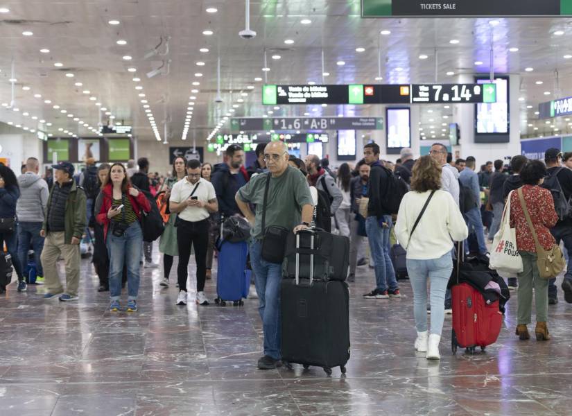 Varios pasajeros esperan en la Estación de Sants de Barcelona después de que el servicio de Rodalies de Cataluña ha quedado suspendido este lunes por la mañana en todo el territorio como consecuencia de las fuertes lluvias.